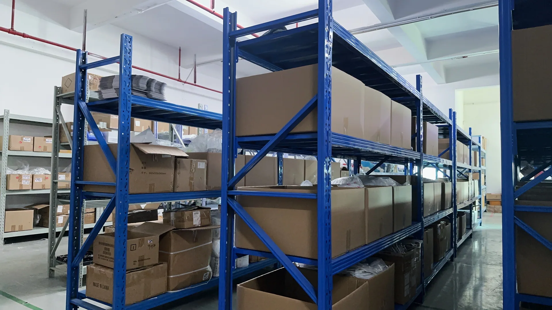 Organized warehouse shelving with components and cartons
