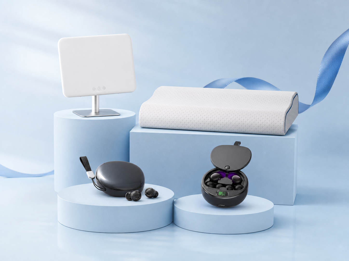 Gold Rose light therapy lamp, smart pillow and sleep earplugs displayed together on blue podiums